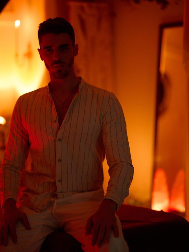 Nicholas in a cozy space lit by ambient lights.