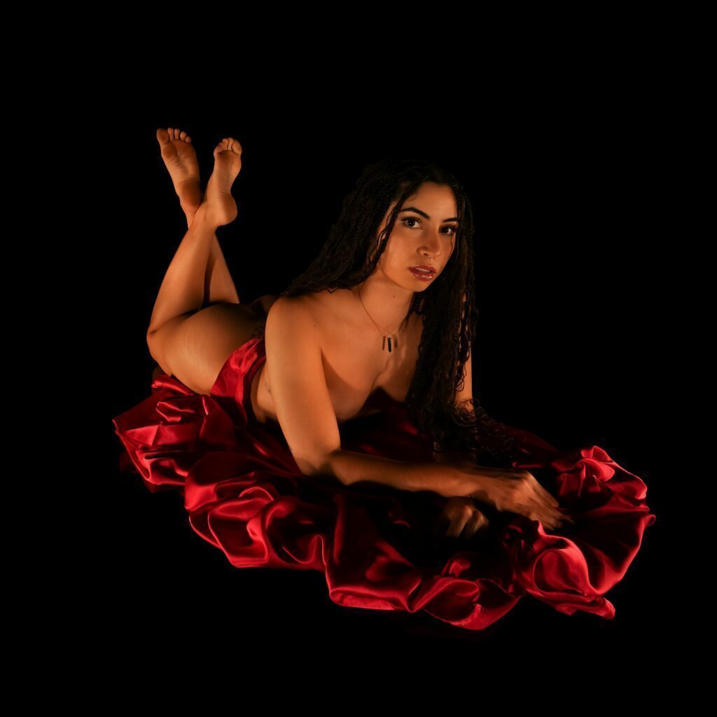 Sensual shot of Selene on the floor wrapped in a red sheet.
