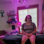 Mischa in zer studio sitting on the bed.