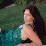 Hannah in a green silky dress.