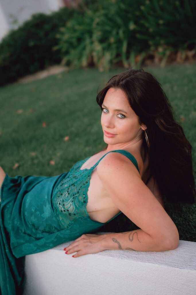Hannah in a green silky dress.