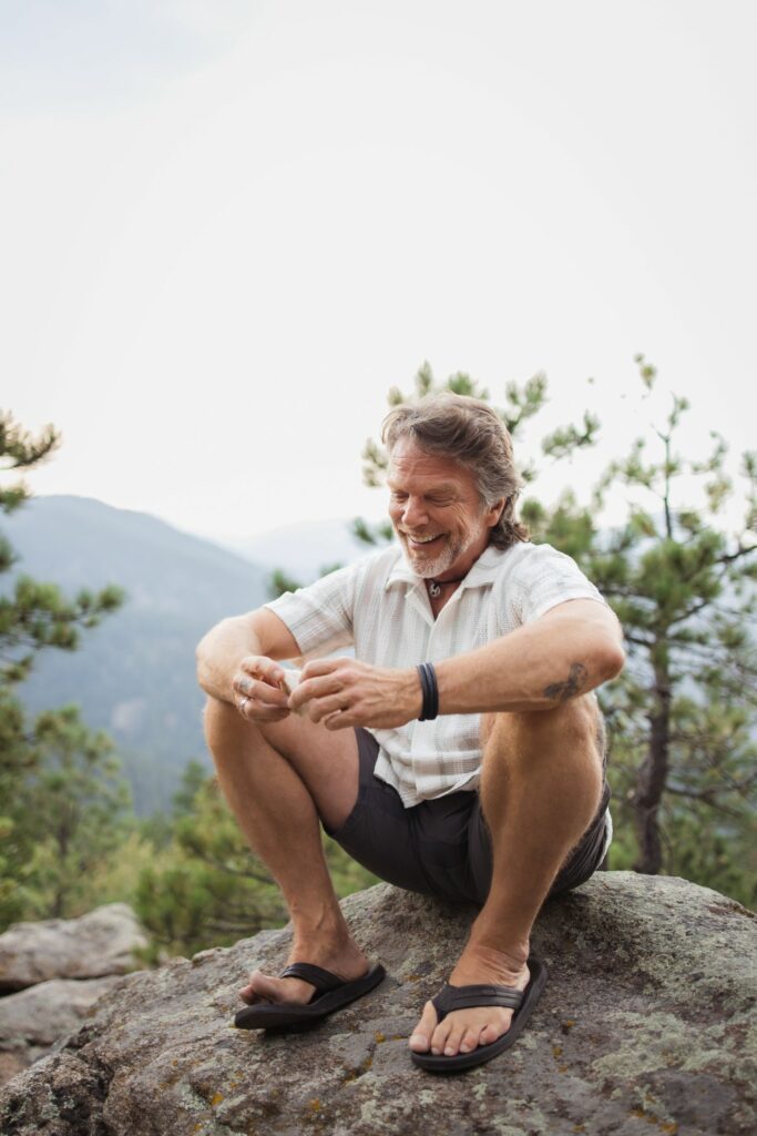 Rich sitting on a rock in the nature.