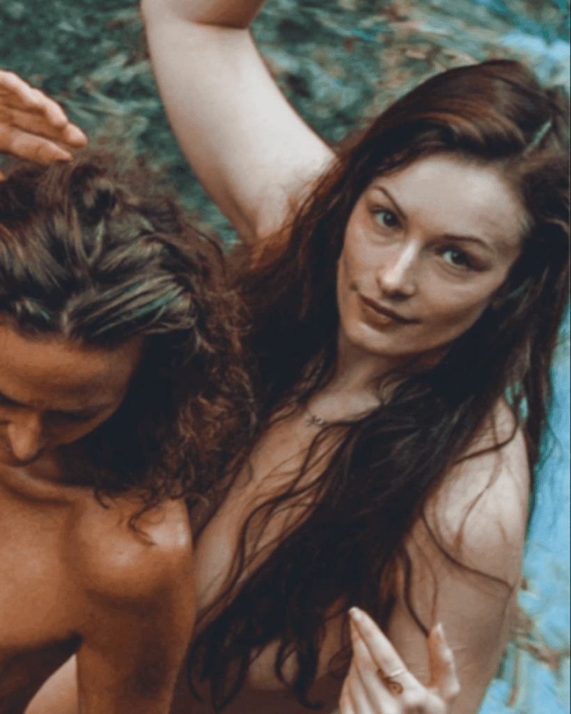 Standing Eleanore with long hair covering her naked body