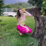 Julioette putting a flower behind her ear.