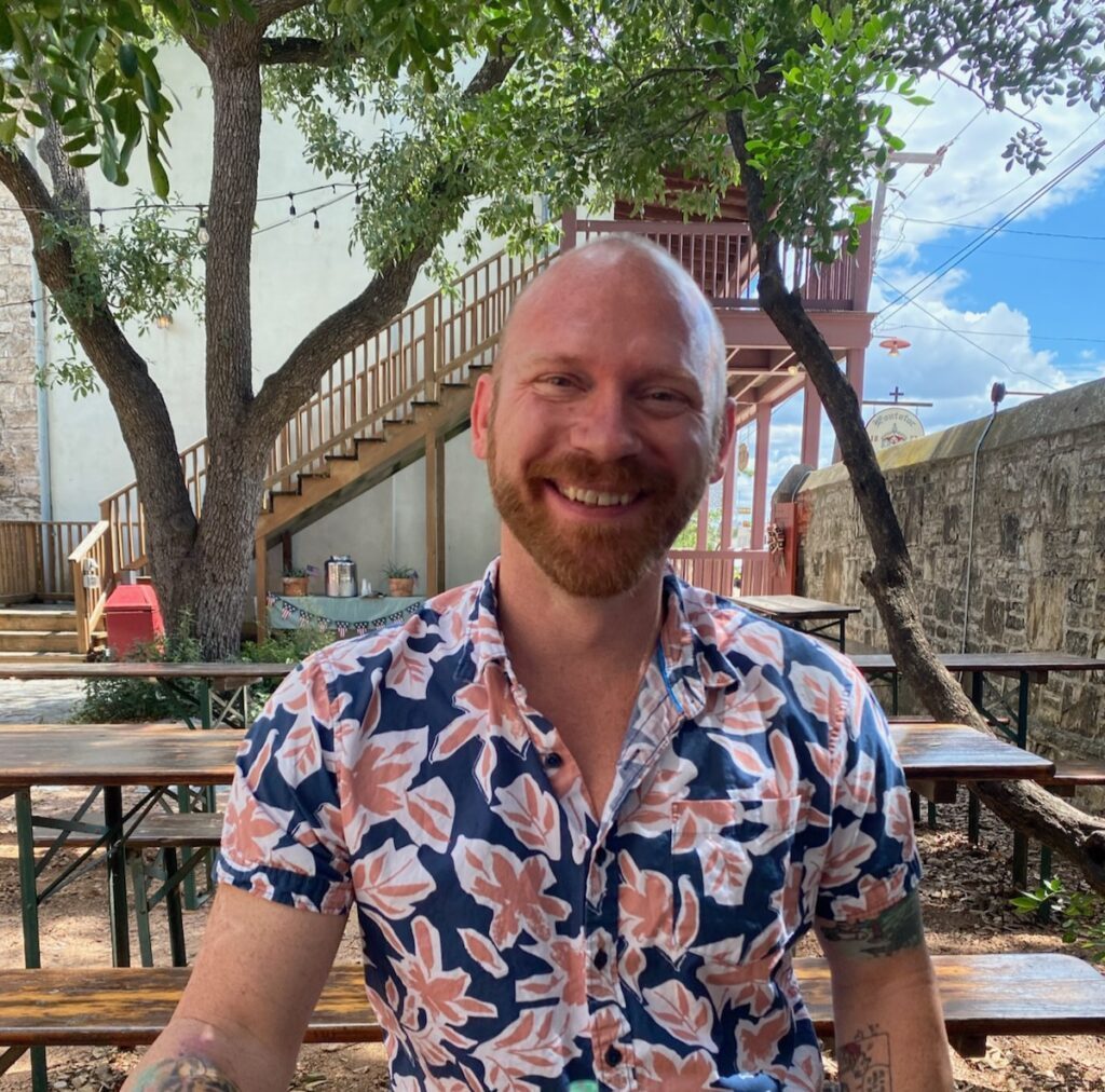 Kinsey in a colordul shirt being smily and shiny.