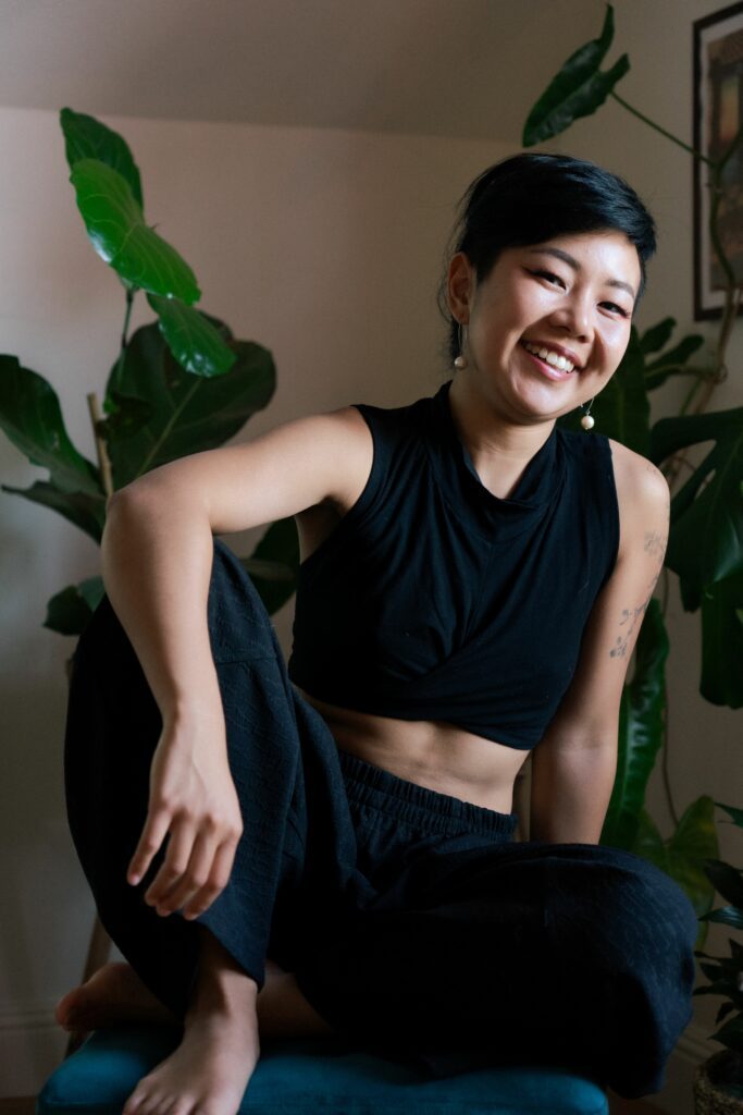 Glory Moonfire in a black outfit with a warm smile.