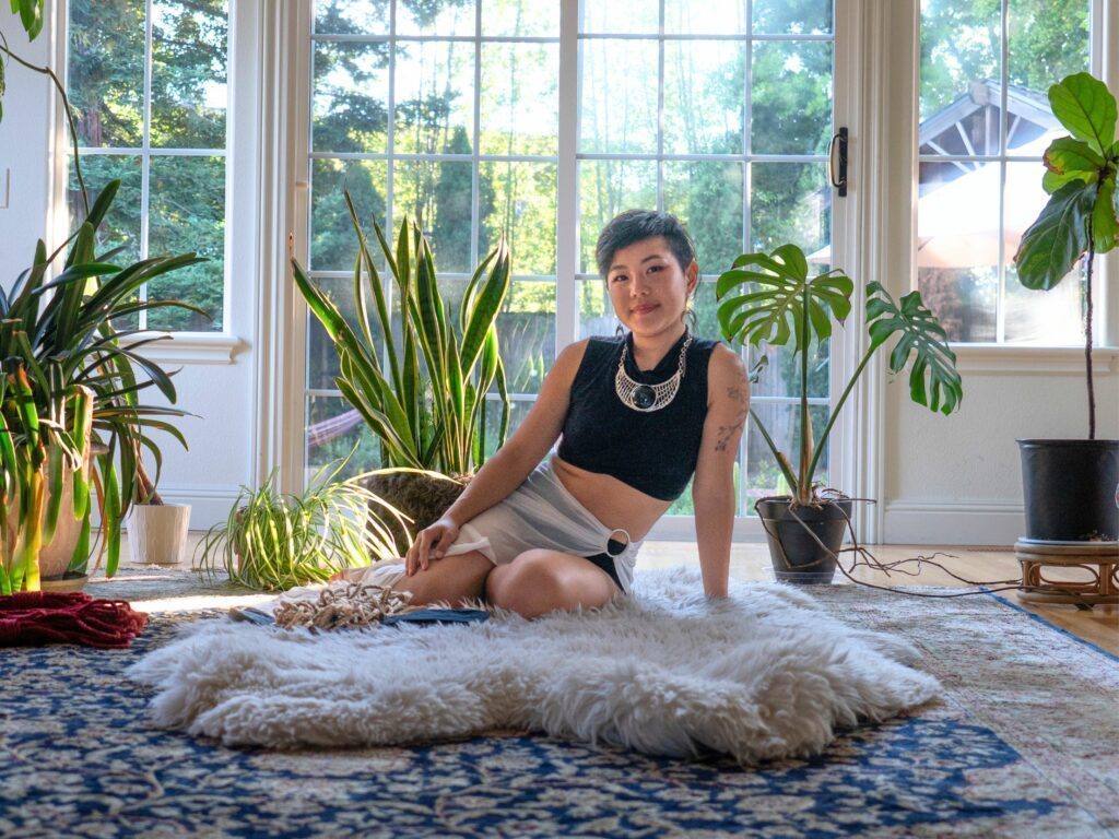 Big open space with lots of light and plants. Glory sitting on a cozy sheepskin