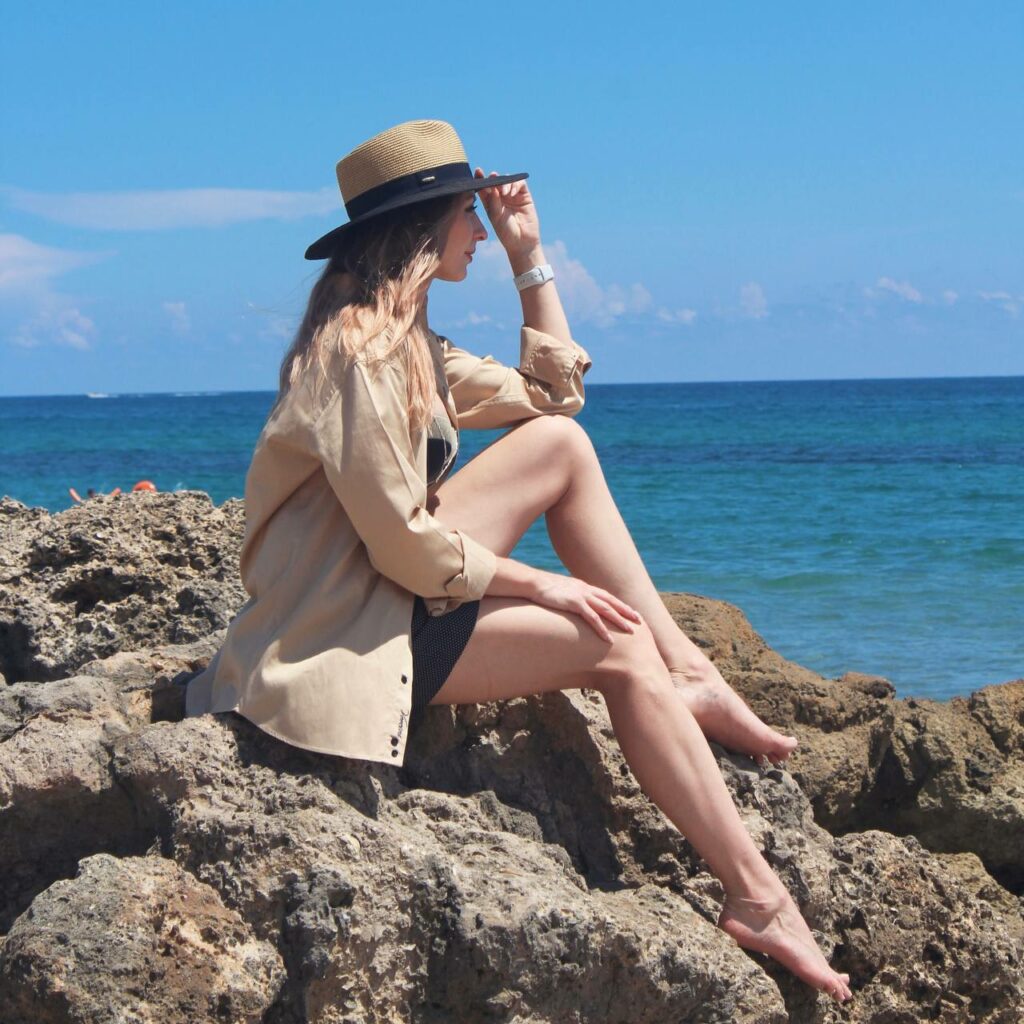 Sitting on the rocks by the sea.