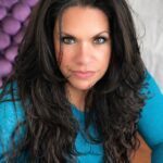 Pamela with an intense gaze and dark long hair.
