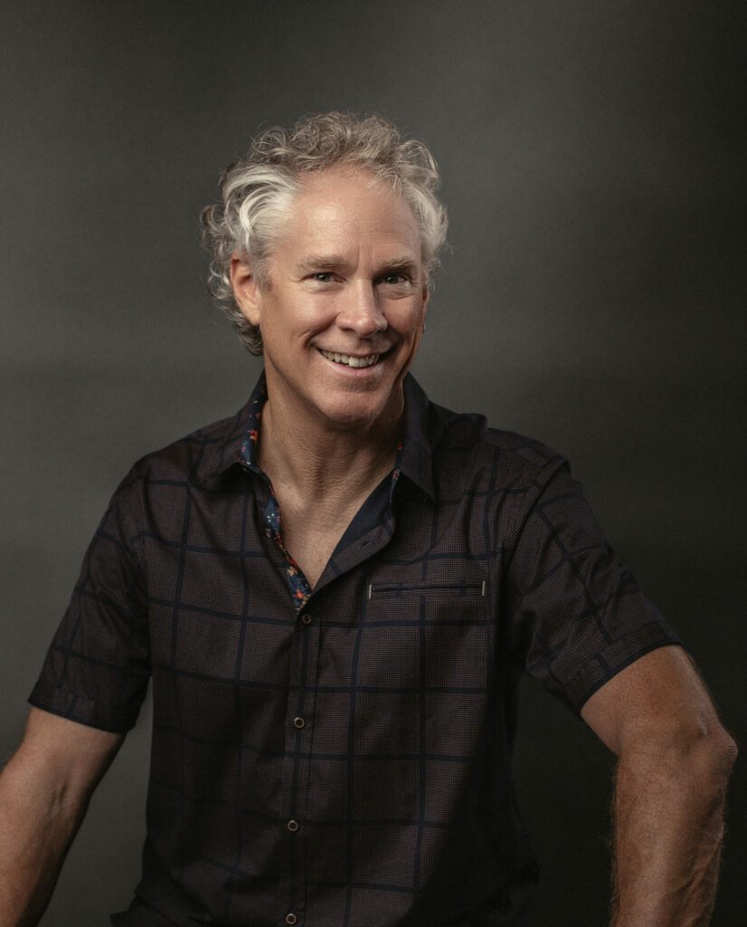 Friendly and smiling DakaDan in a dark shirt.