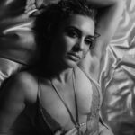 Sensual shot of Jo on a bed with silky linen