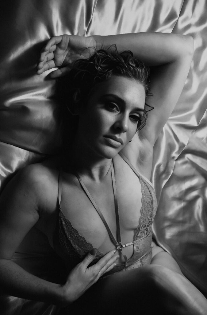 Sensual shot of Jo on a bed with silky linen