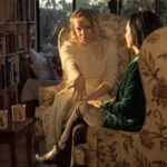 Kat and her client sitting in armchairs and interacting.