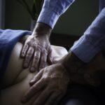 Eric's hands giving his client a massage.