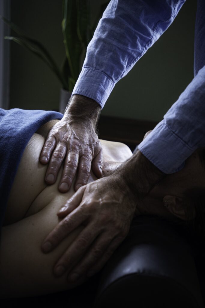 Eric's hands giving his client a massage.