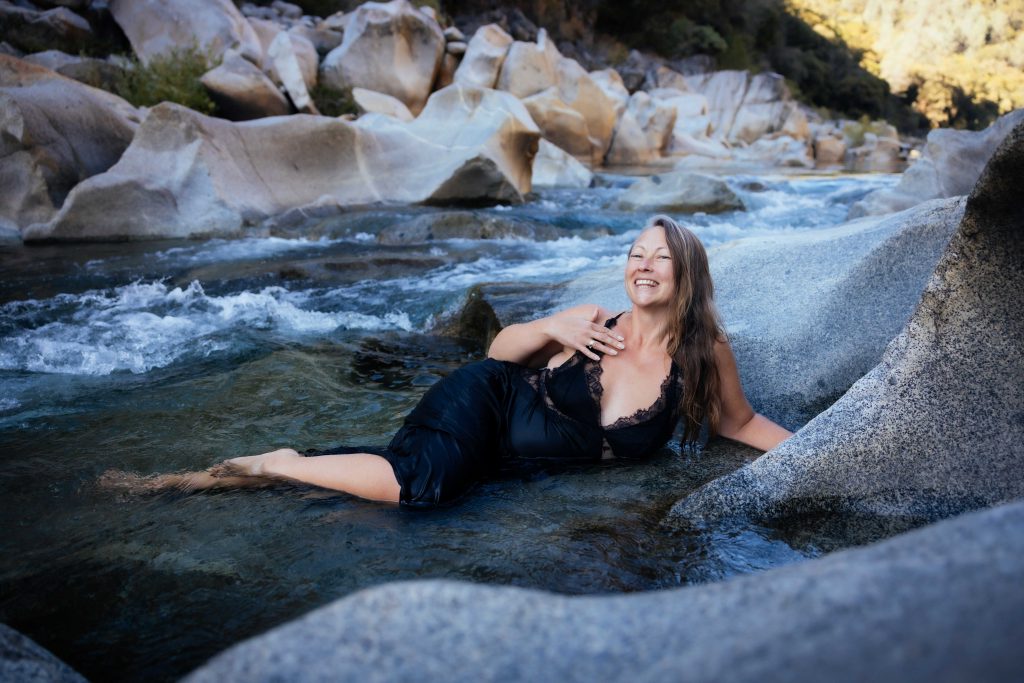Veritie bathing in a wild river.