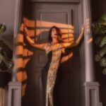 Flamboyant doorway with the sunset light striking it. Natalia standing in the middle.