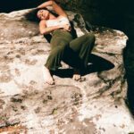 Ariadne laying down on a big rock.