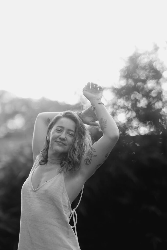 Black&white shot of Kay Love holding her hands above her head.