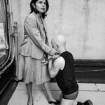 Male client kneeling in front of Mistress Amada.