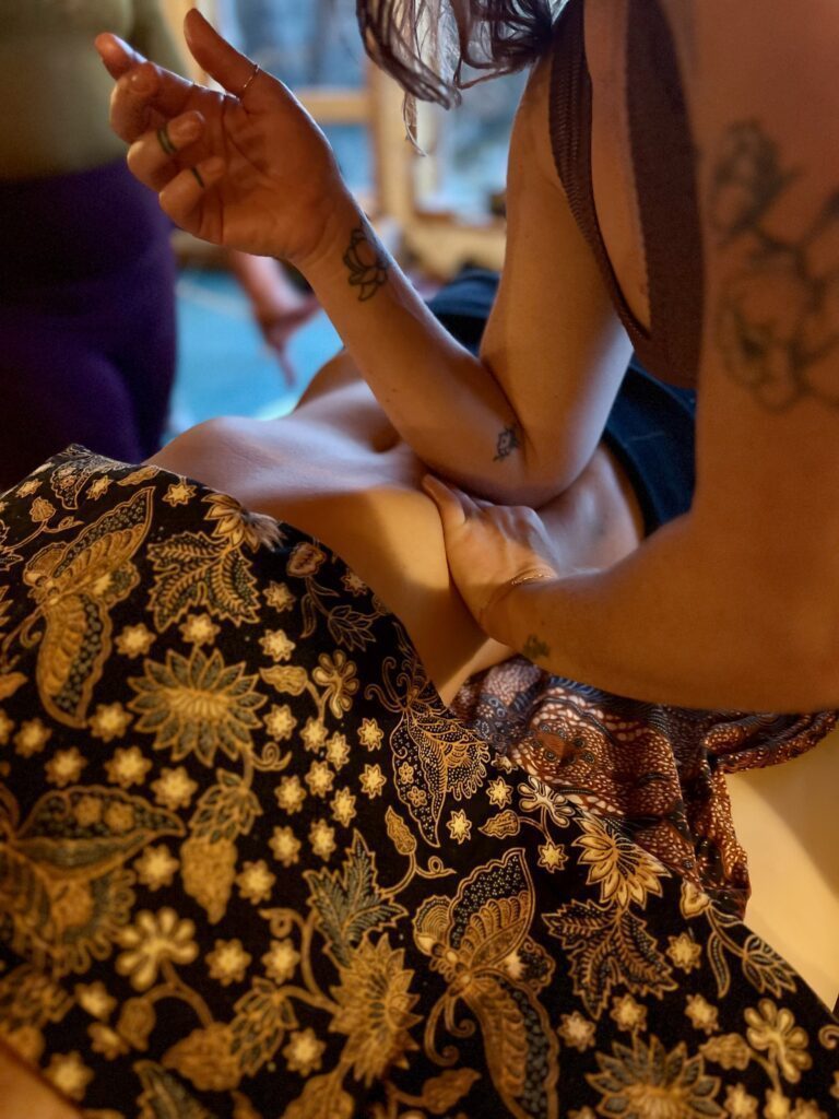 Close-up of Kay Love's hands giving massage to a client.