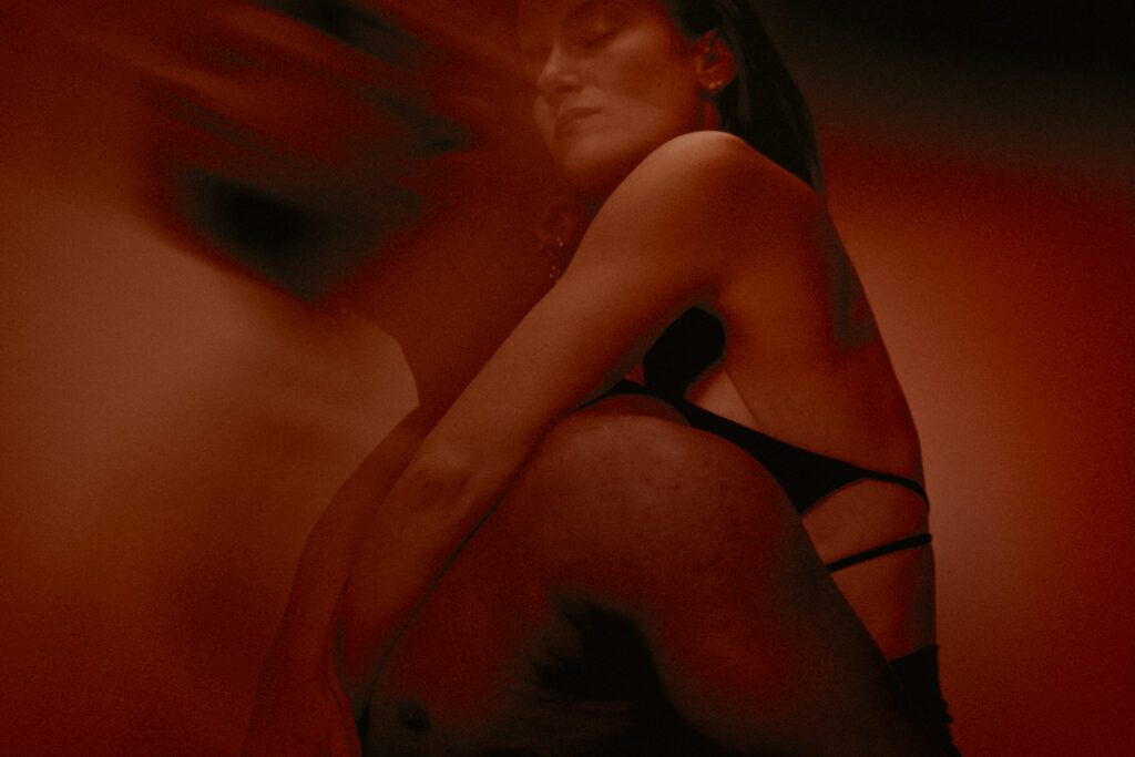 Artistic shot of paleta, blurry face, shadows and different tones of red.
