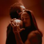 Embracing a man. Red light surronding them.