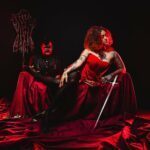 LadyKin and a male client in a flamboyant scene.