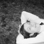 Black and white photo of Roman lying down with a warm smile.