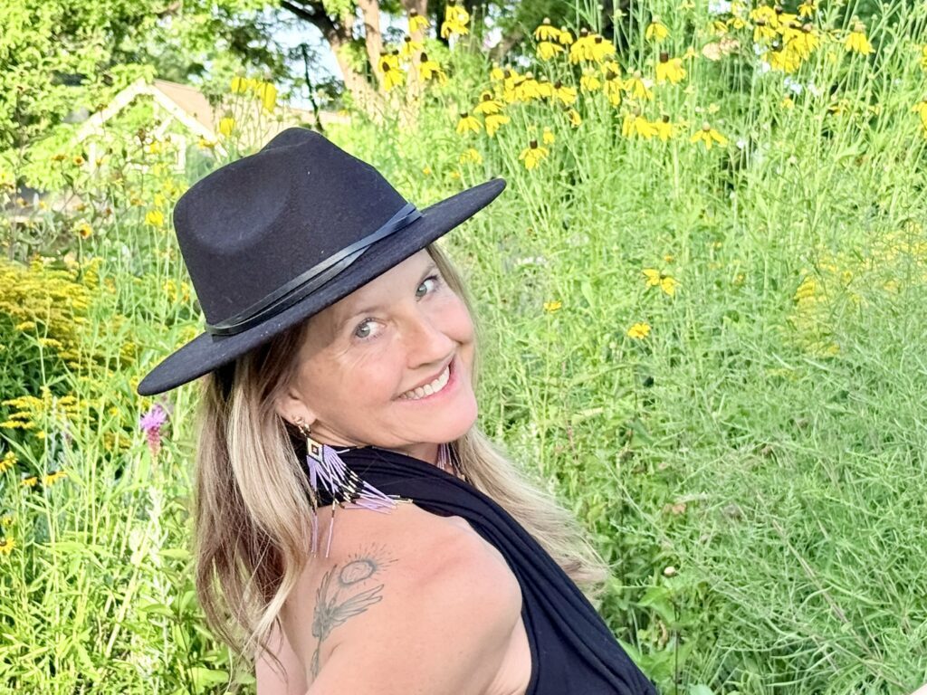 Looking over the shoulder towards the camera with wildflowers in the background