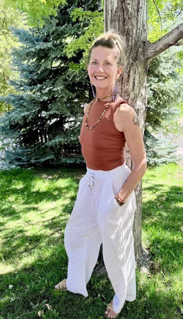 Casual LeAira standing in front of a tree with a big smile
