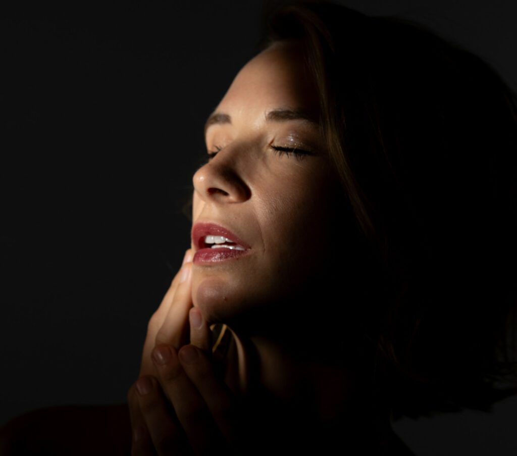eyes closed red lips light on face