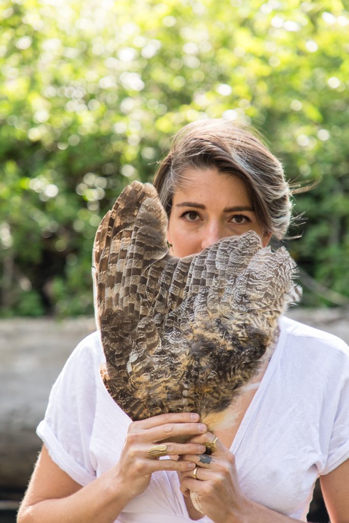 Gaia holding a birds wing.