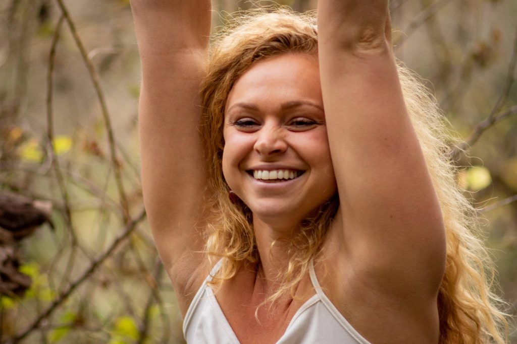 Big smile and hands lifted up.