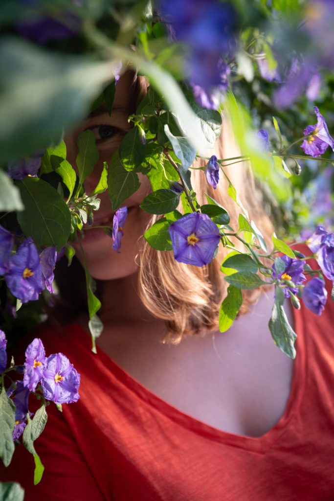 Heather peeking out from a flower bush.