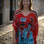 Heather on the street in a colorful dress.