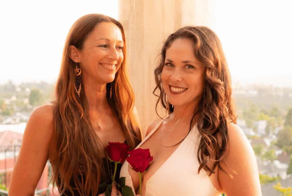 CLose up of the alchemists duo holding roses.