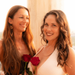CLose up of the alchemists duo holding roses.